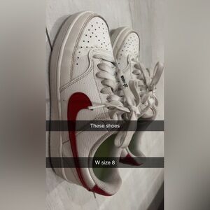 Nike shoes with dark red stripe